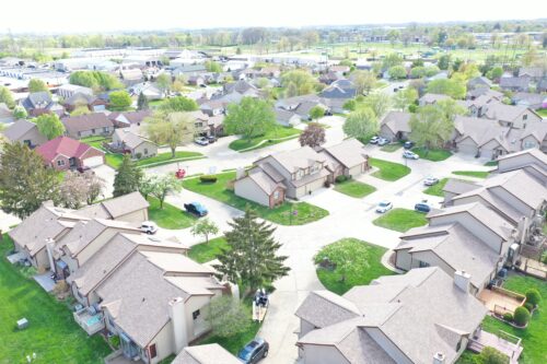 Aerial view of a housing complex with new light brown asphalt roofs - Big Boy's Construction
