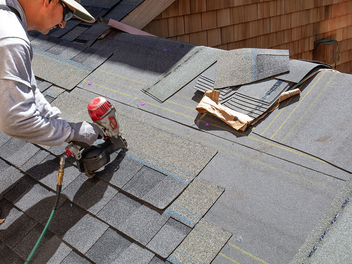 1200x900GMB-3 A worker laying new shingles.