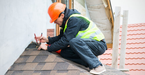 man fixing roof