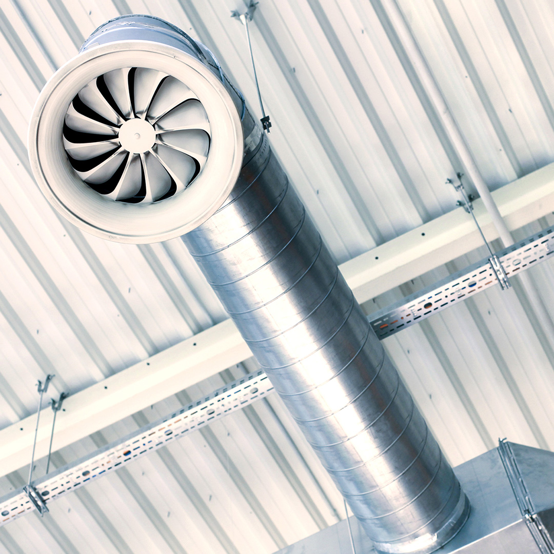 A ventilation duct below a metal roof