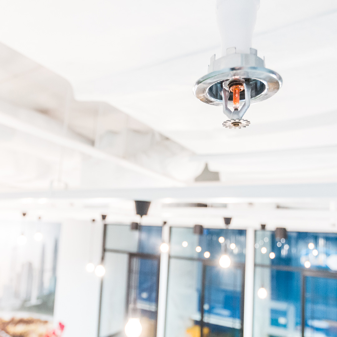 An emergency fire sprinkler on a ceiling