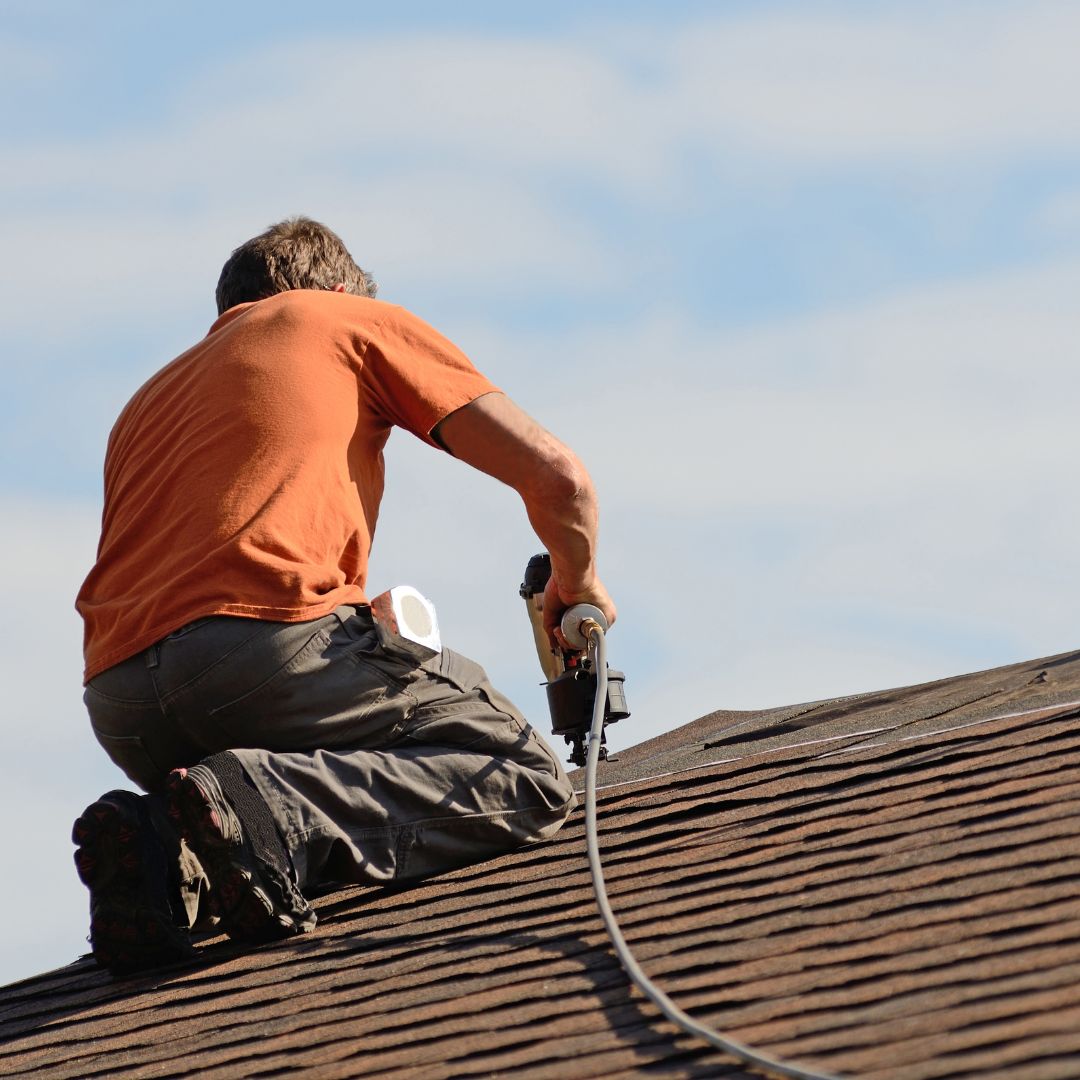 BlitzTitle-1080x1080-image2 Roofer using drill on roof