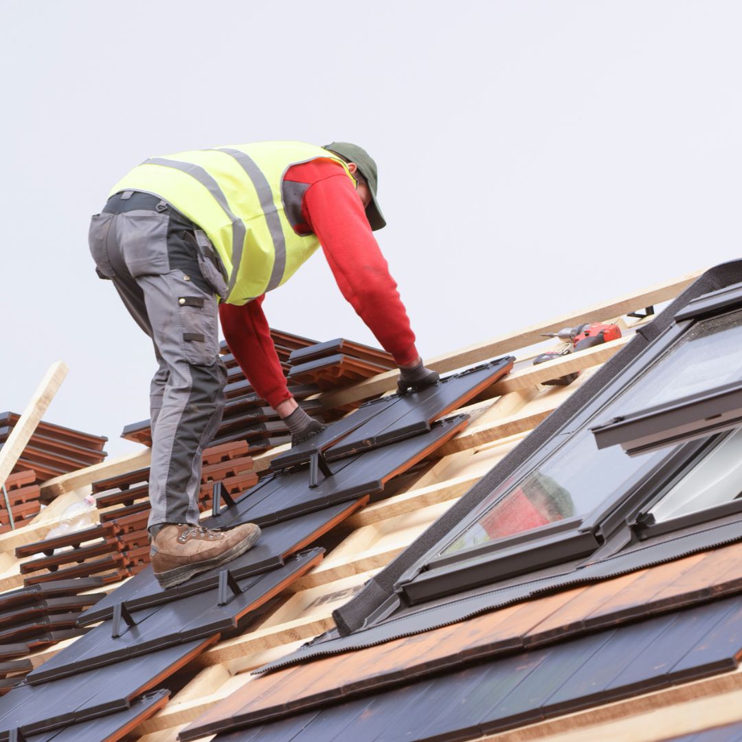 commercial roofer working on the roof