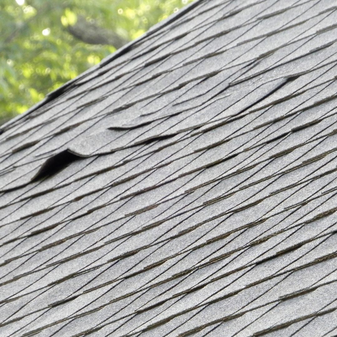 a roof with curling shingles