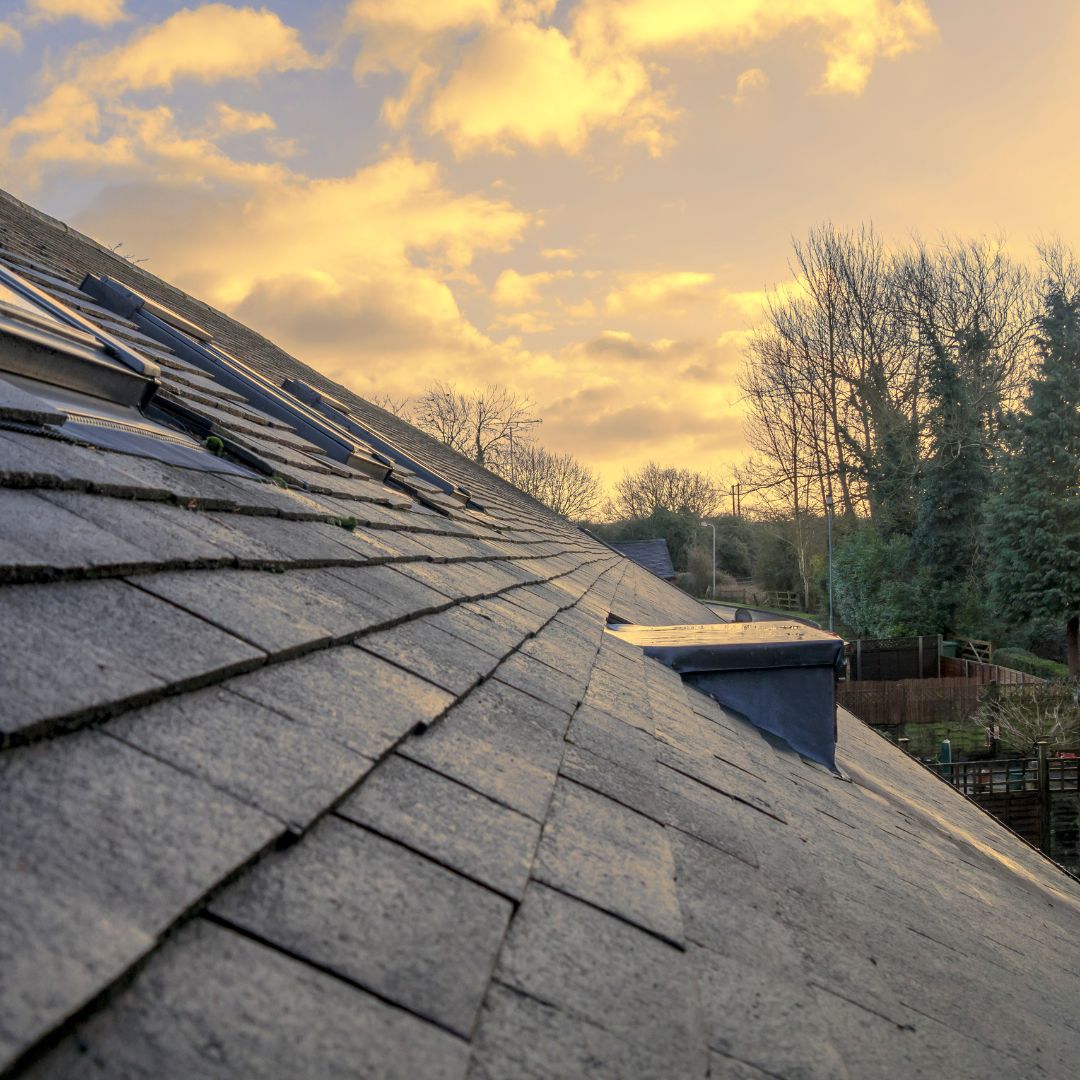 the view of a roof with a sunset in the background