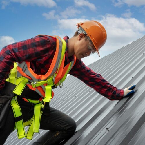 roofer working on a metal roof