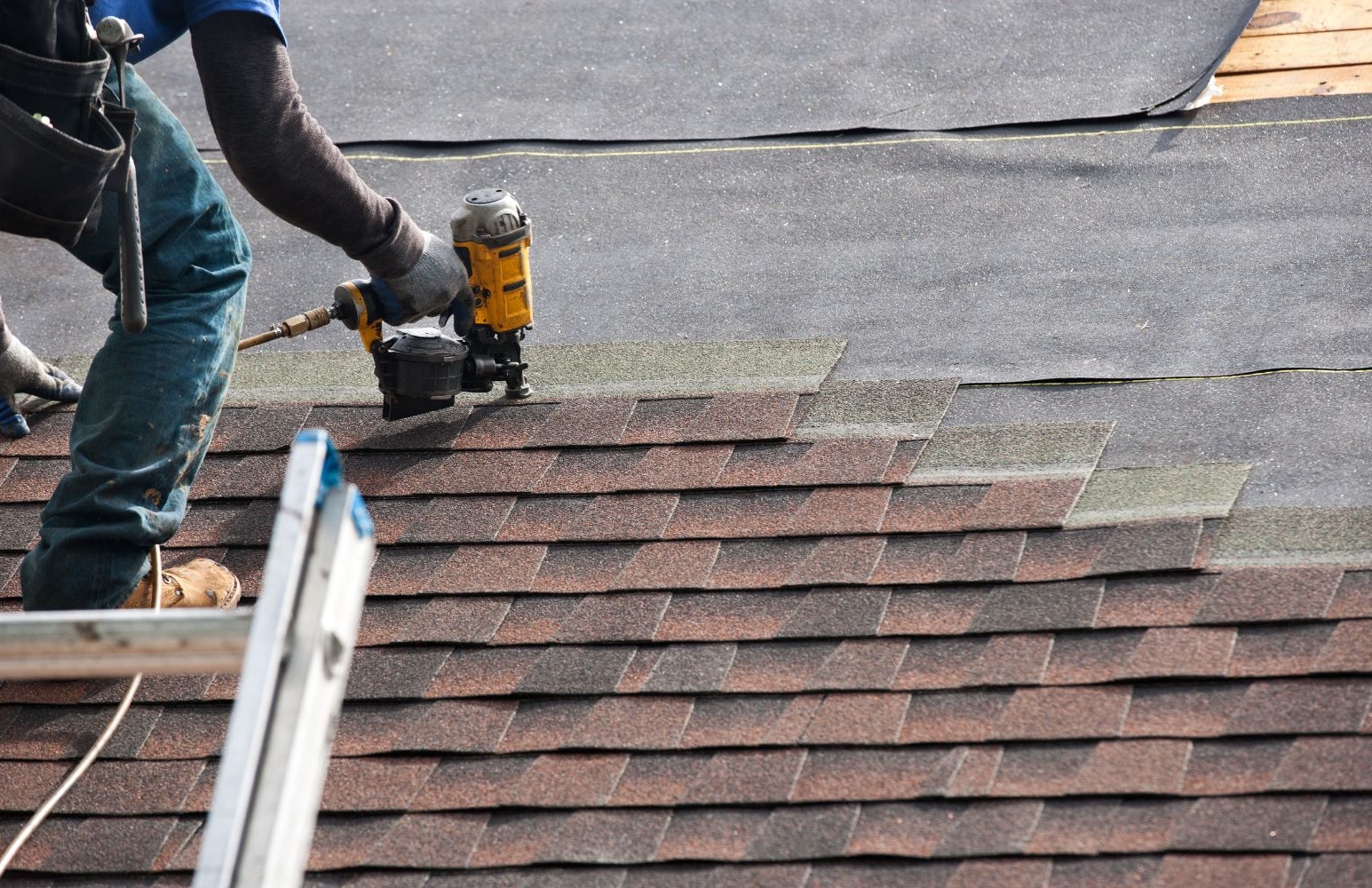 Untitled design - 3 img of a roofer repairing a roof
