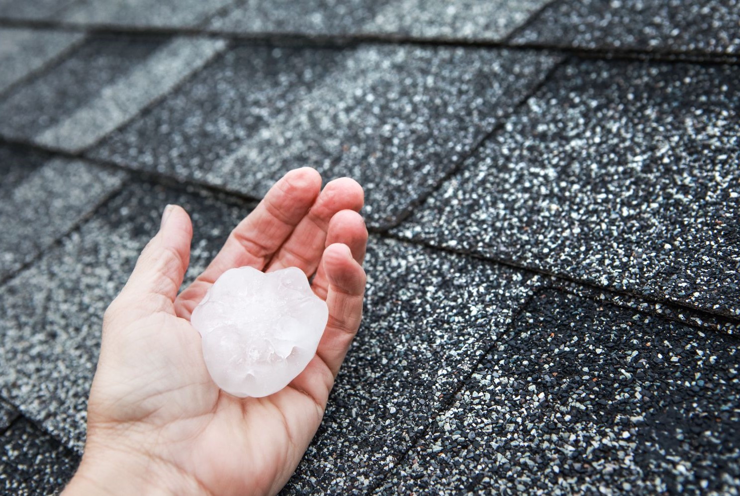 M29034 - Big Boy's Construction - Whitestown Roofing Contractor - PB - img3 img of someone holding hail on their roof