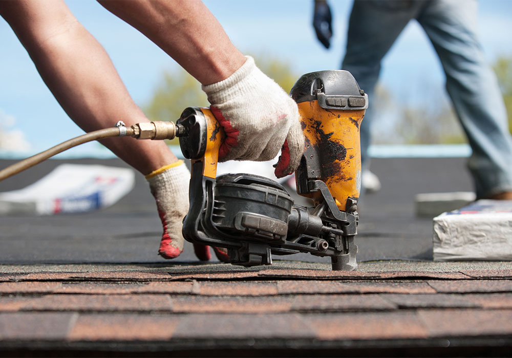 Image 2 using nail gun in roof repair