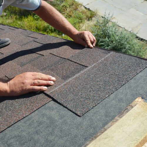 roofer fixing shingles