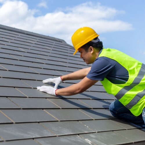 roofer fixing shingles