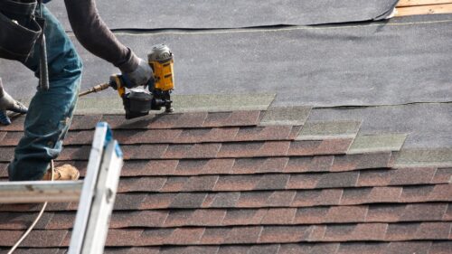 roofer putting on shingles