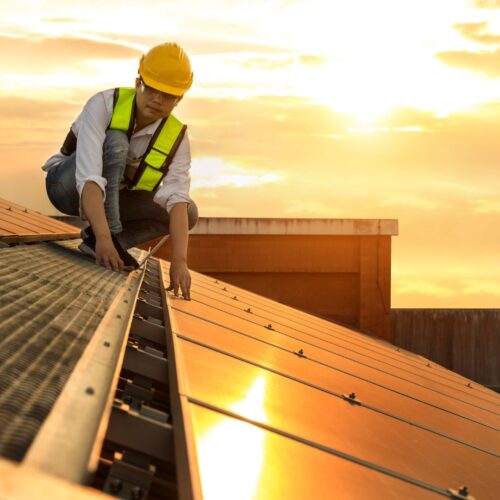 A contractor working on a metal roof