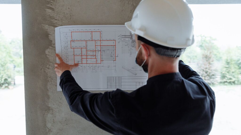 A contractor looking through blueprints