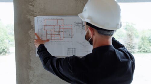 A contractor looking through blueprints
