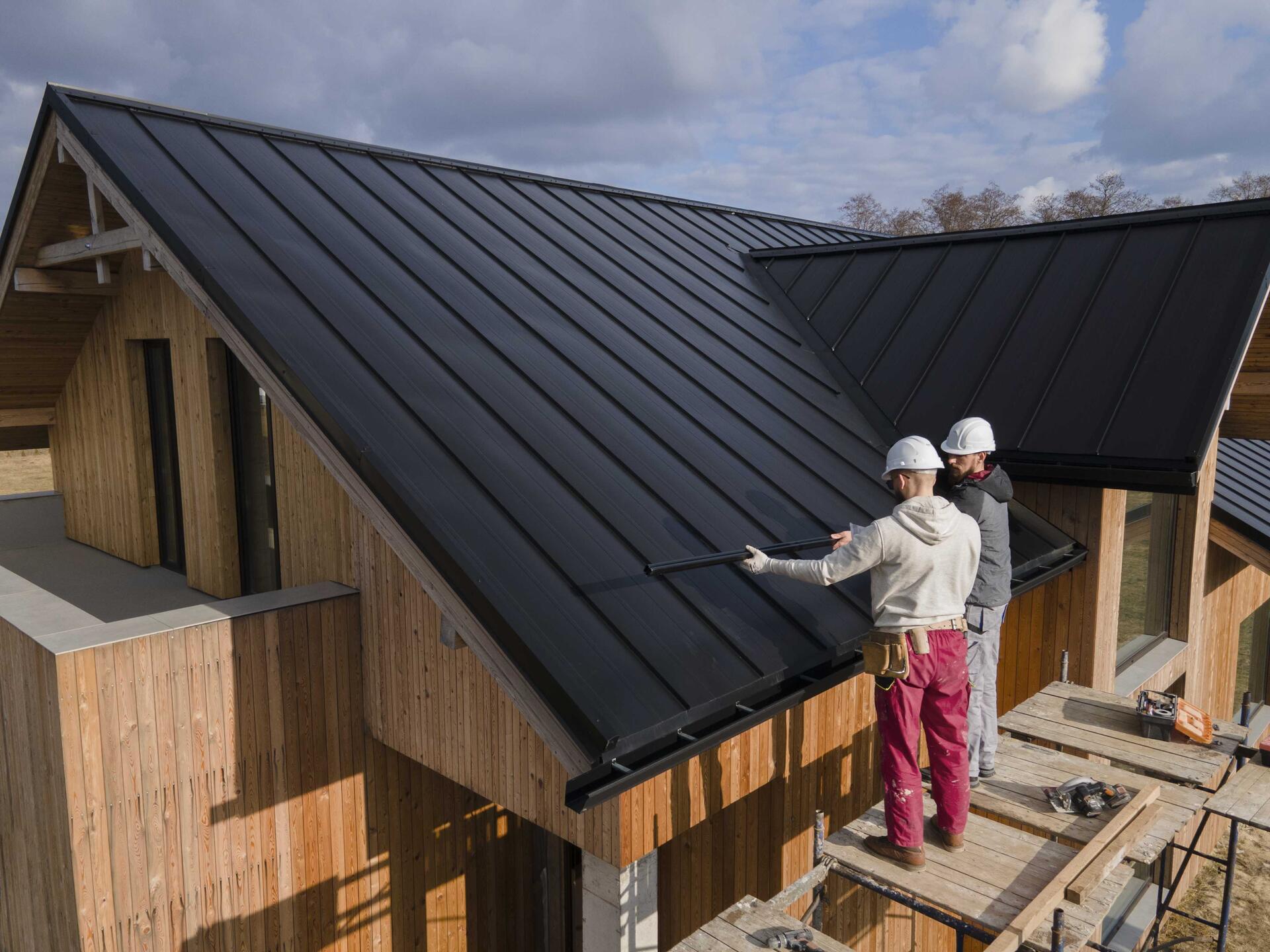 full-shot-roofers-working-together-with-helmets-min