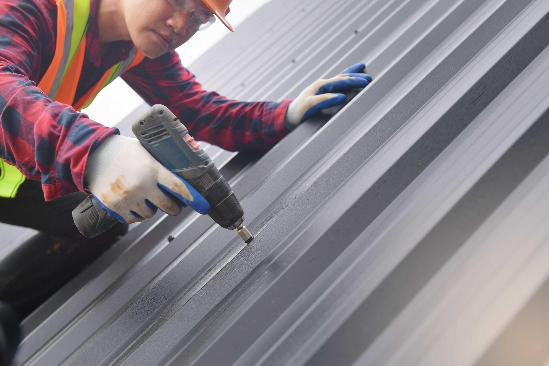 vecteezy_close-up-drill-roofer-worker-in-protective-uniform-wear-and_15632765-min